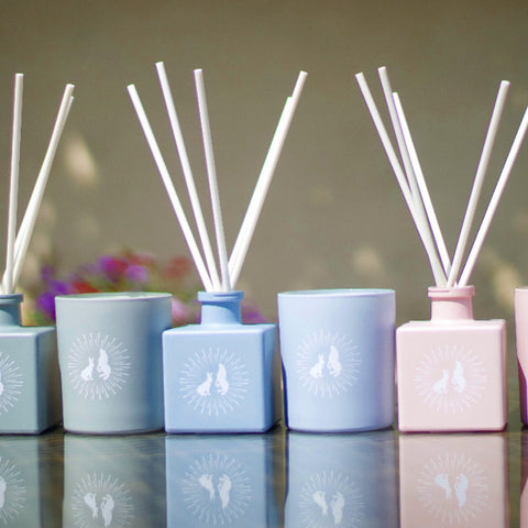 Pink, blue and grey scented candles and room diffusers